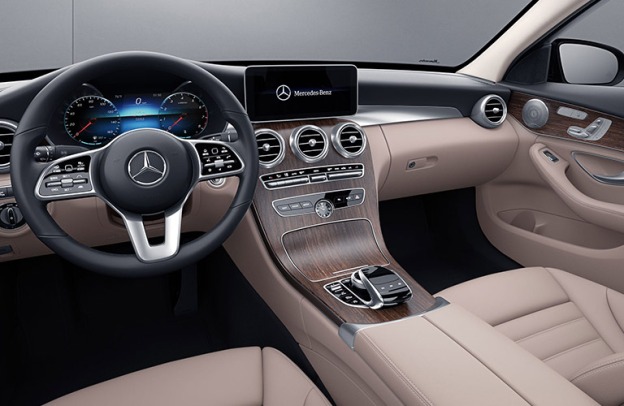 Interior cabin of a 2020 Mercedes-Benz C-Class. The infotainment screen reads, "Mercedes-Benz," next to a brand logo.